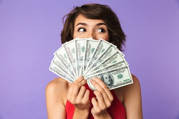 Happy Pretty brunette woman covering her face with money